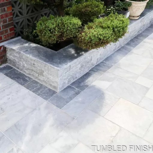 Afyon Ice Marble pavers in outdoor landscaping in Hawthorne, NJ, displaying a blend of icy tones.