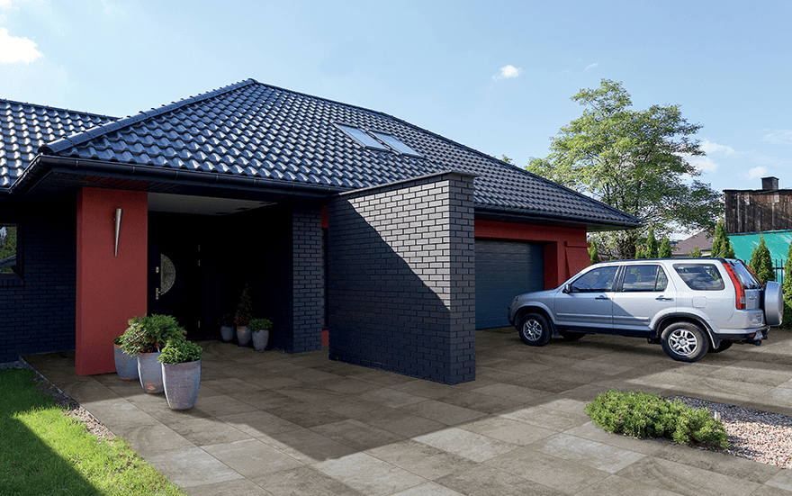 Modern driveway of large square pavers in linear grid pattern