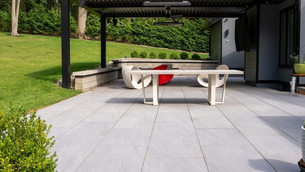 Modern outdoor small patio with large light gray pavers laid in a linear pattern 1